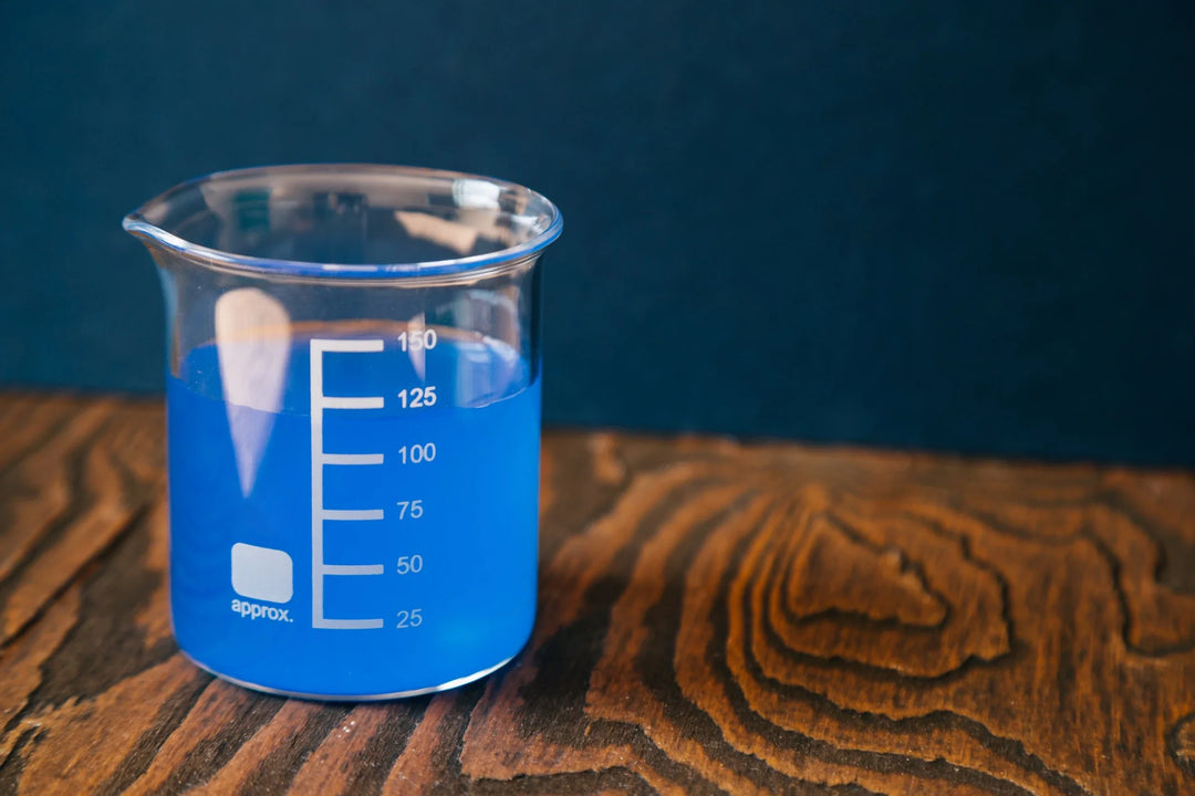 glass container with blue liquid