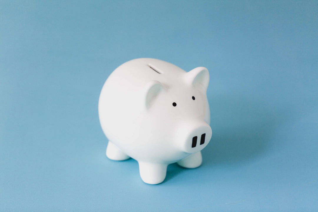 A white piggy bank on a light blue background.