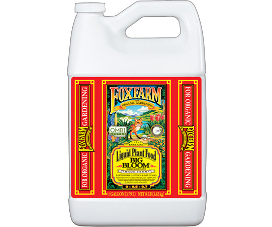 Gallon size white plastic bottle with red label and yellow lettering of plant food