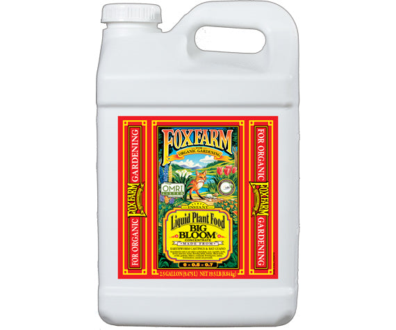 2.5 Gallon size white plastic bottle with red label and yellow lettering of plant food